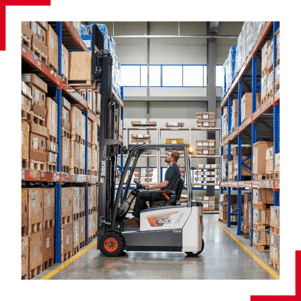 Bobcat 3-wheel electric forklift (1) Bobcat 3-wheel electric forklift lifting a pallet in aisle