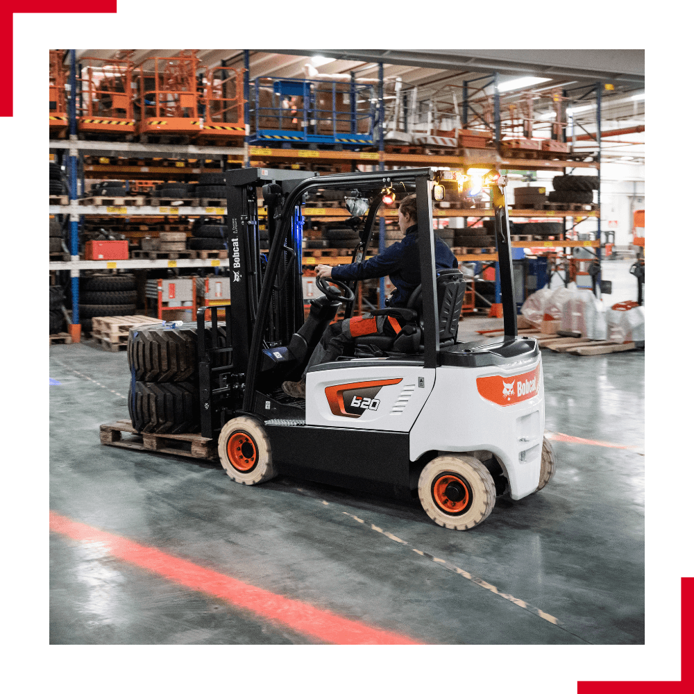 Bobcat 4-wheel electric forklift (1) Bobcat 4-wheel electric forklift transporting tyres in warehouse